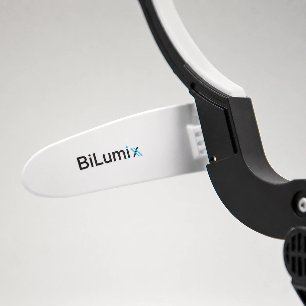 BiLumix white forehead plate installed on a compatible dental headlamp