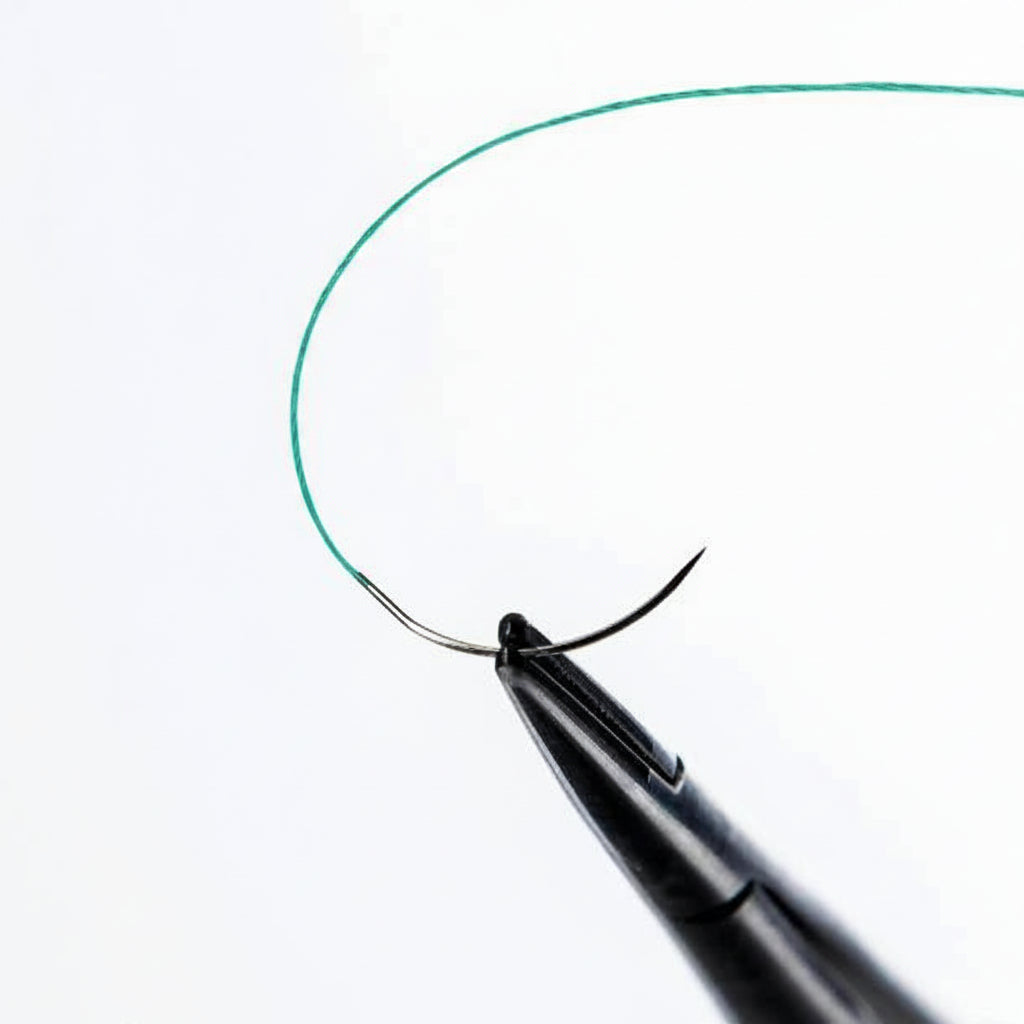 Close-up of 13 mm 3/8 circle Black Narrow needle for Techsuture Nylon Soft Blue Suture USP 5-0